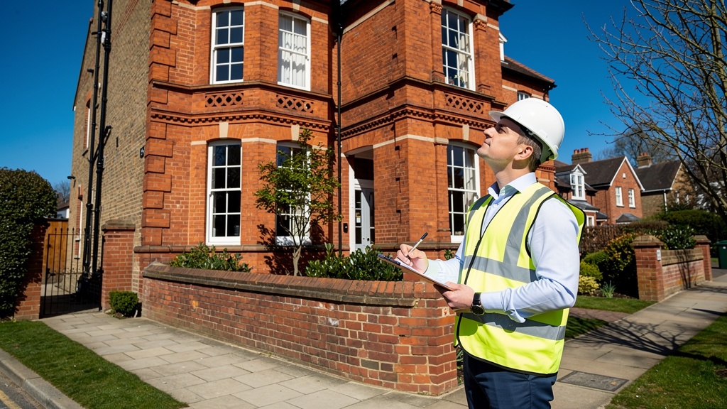 Professional surveyor inspecting a Victorian property in Surrey