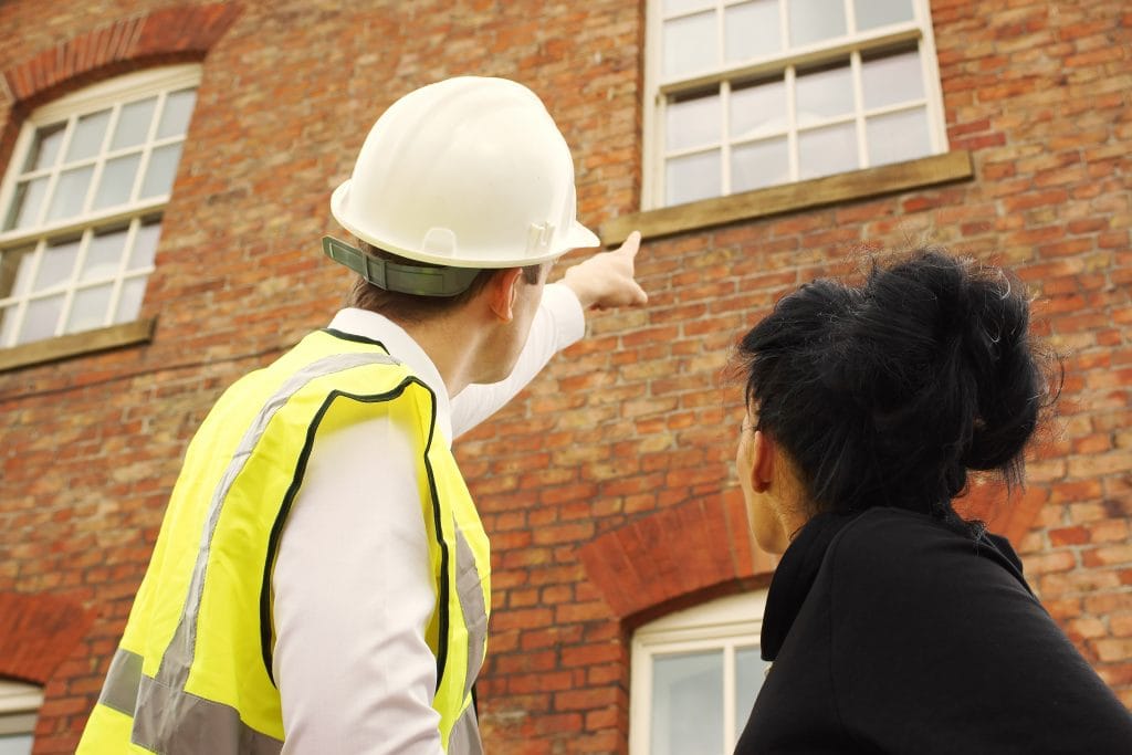 Building surveyor inspecting structural defects inside a Victorian property